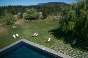 an aerial view of a yard with chairs and a swimming pool at Loi Suites Chapelco Hotel in San Martín de los Andes