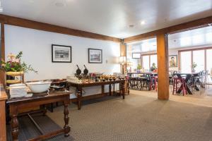 a room with tables and chairs and a dining room at Silver Baron Lodge in Park City