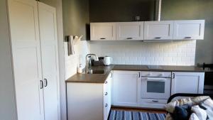 a kitchen with white cabinets and a sink at Apartment Úvoz Street 64 in Brno
