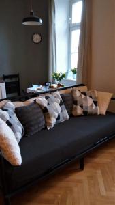 a couch with pillows on it in a living room at Apartment Úvoz Street 64 in Brno