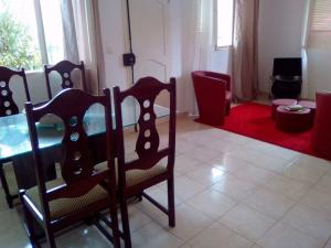 ein Wohnzimmer mit einem Esstisch und Stühlen in der Unterkunft Casa Mendes in Tarrafal
