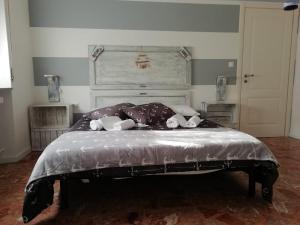 a bedroom with a large bed with a headboard at Good Morning Shopping in Serravalle Scrivia