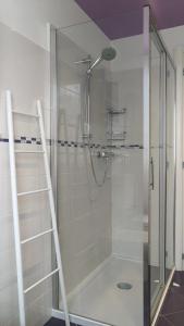 a shower with a glass door in a bathroom at Good Morning Shopping in Serravalle Scrivia