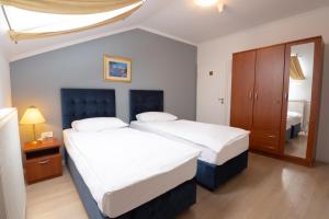 Postel nebo postele na pokoji v ubytování Hotel Vila Tina