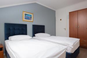 Postel nebo postele na pokoji v ubytování Hotel Vila Tina