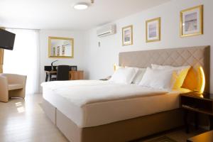 Postel nebo postele na pokoji v ubytování Hotel Vila Tina
