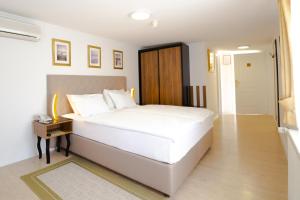 Postel nebo postele na pokoji v ubytování Hotel Vila Tina