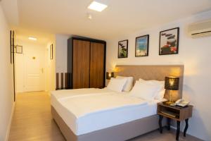 Postel nebo postele na pokoji v ubytování Hotel Vila Tina