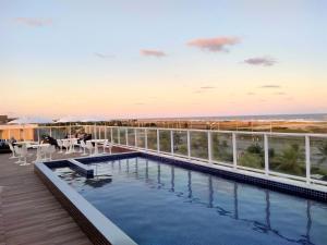 a swimming pool on the roof of a building at Simas Praia Hotel in Aracaju