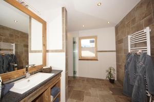 a bathroom with a sink and a mirror at Kaiserappartements-Marie in Ellmau +107 photos