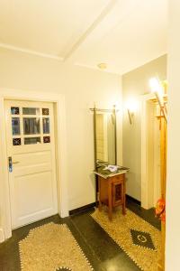 a room with a door and a table and a mirror at finkeshaus in Lüdinghausen