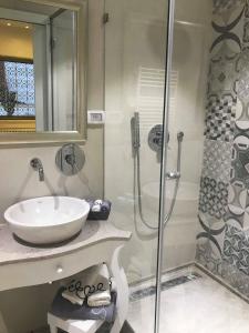 a bathroom with a sink and a shower at Dar Corniche La Marsa (Adults Only) in La Marsa