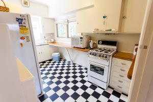 a kitchen with a black and white checkered floor at Point Lonsdale Beach House in Point Lonsdale