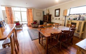 a living room with a wooden table and chairs at Point Lonsdale Beach House in Point Lonsdale
