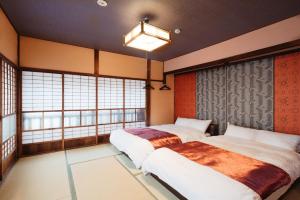 Postel nebo postele na pokoji v ubytování LAMP Iki