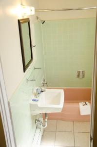 a bathroom with a sink and a mirror at Budget Inn & Suites Colby in Colby