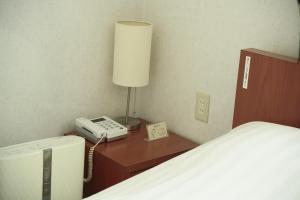 Postel nebo postele na pokoji v ubytování Hotel New Takada