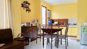 a kitchen with a table and chairs in a room at Jireh’s Guests Home in Butuan