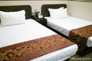 Ένα ή περισσότερα κρεβάτια σε δωμάτιο στο B&B Mongkok Hotel