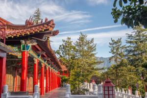 a pagoda with red columns in front of a building at Lishan Guest House in Heping