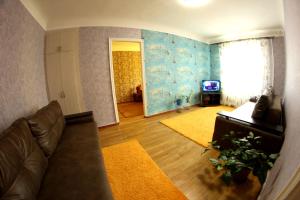 a living room with a couch and a television at Большая Перспективная 46 in Kropyvnytskyi +1 photo