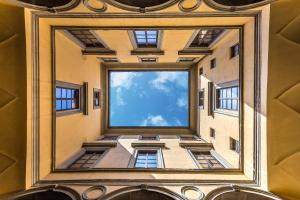 a painting of a building with a window at Palazzo Ridolfi - Residenza d'Epoca in Florence