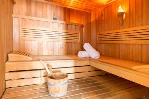 a wooden sauna with a bucket in the middle at Hôtel Régent Contades in Strasbourg