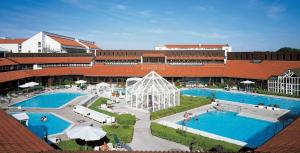 a hotel with two swimming pools and a building at Hotel Fortuna in Bad Gögging