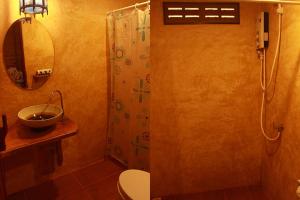 a bathroom with a shower and a toilet and a sink at Longtail Beach Resort in Thong Nai Pan Yai