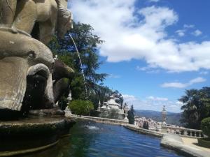a fountain in a park with a statue in the water at O Cantinho do Colégio - Dourocollege in Lamego