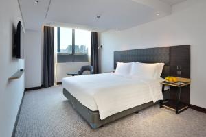 a hotel room with a bed and a table with fruit on it at Camlux Hotel in Hong Kong