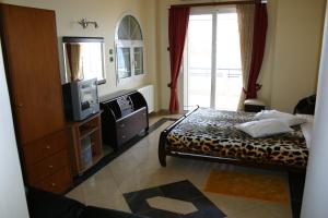 Postel nebo postele na pokoji v ubytování Petit Palais Hotel