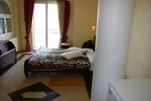 Postel nebo postele na pokoji v ubytování Petit Palais Hotel