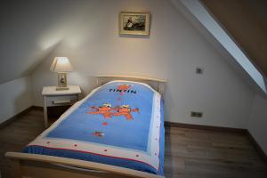 a childs bedroom with a bed in a attic at Le Nid Des Grands Geais in Le Crotoy