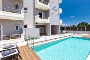 a swimming pool in front of a building at Ethereal Apartments Chania in Souda