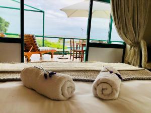 a hotel room with two towels on a bed at Sandra's Guest House in Langebaan