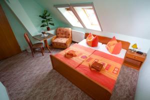 a bedroom with a bed and a chair and a table at Christel's Pension in Brandenburg an der Havel