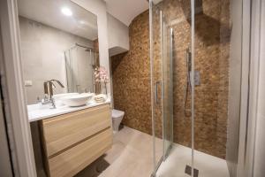 a bathroom with a sink and a shower at Cosy Apartment with Terrace in the Centre of Seville in Seville