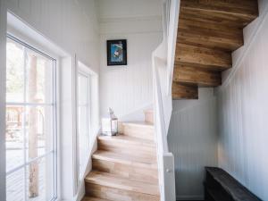 a staircase in a house with wooden floors and a window at Trasti & Trine Boutique Hotel in Alta