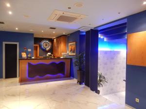 a lobby with blue walls and a counter at Athens Lydia Hotel in Athens