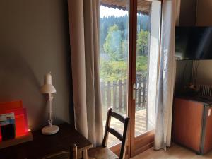 a room with a table and a window with a view at Hôtel Les Chamois in La Bollène-Vésubie