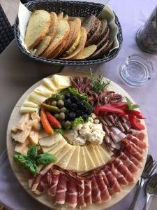 eine Platte mit verschiedenen Arten von Lebensmitteln auf einem Tisch in der Unterkunft Guest House Villa Maslina Neum in Neum