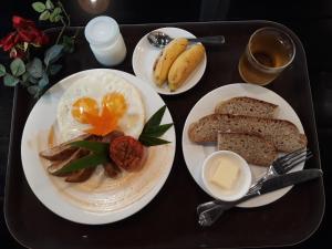 a table with two plates of eggs and bread at The Hill Resort in Phú Quốc