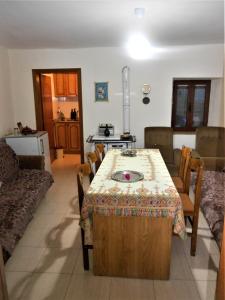 a living room with a table and a couch at Guest House Taunus in Berat
