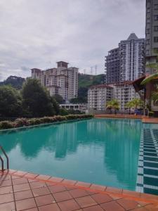a large swimming pool in a city with tall buildings at A Ted House @ Damansara Perdana in Petaling Jaya
