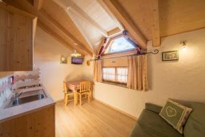 a kitchen with a sink and a table in a room at Camping Catinaccio Rosengarten in Pozza di Fassa