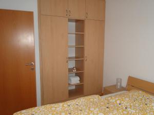 a bedroom with a bed and a cupboard at Zele in Dolac