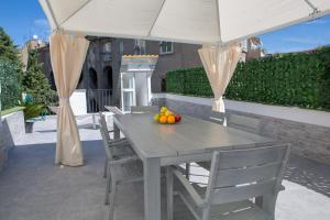 a table and chairs under a white tent with fruit on it at Holiday House Tot&ograve; in Naples
