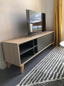 a entertainment center with a flat screen tv on it at The Site apartment in Pas de la Casa