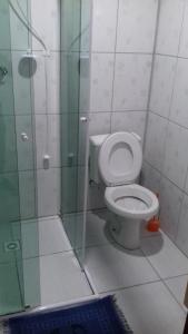 a bathroom with a toilet and a glass shower at Casa do Vo Lelo in Penha +17 photos